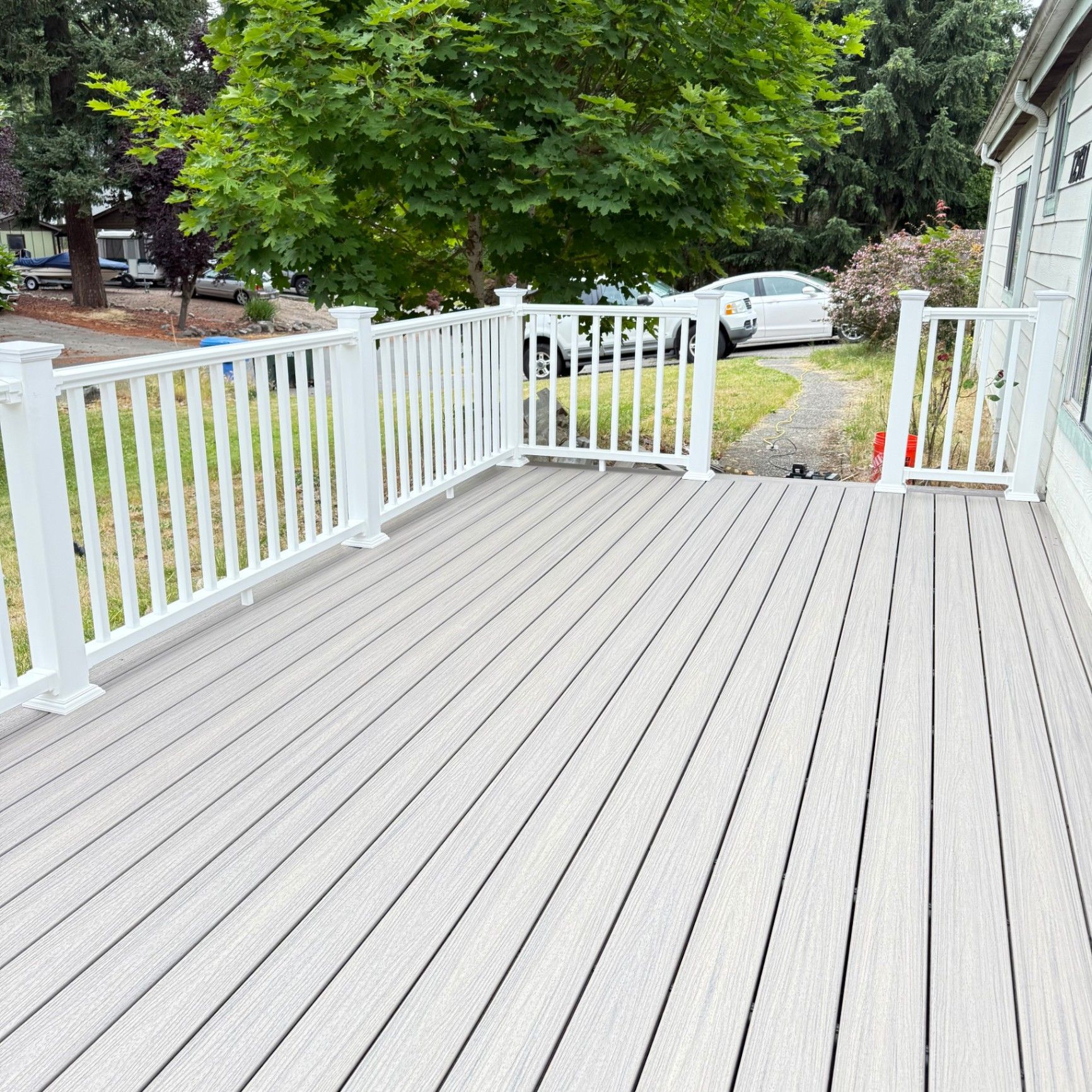 Long cedar fence following the edge of a residential yard under a clear sky
